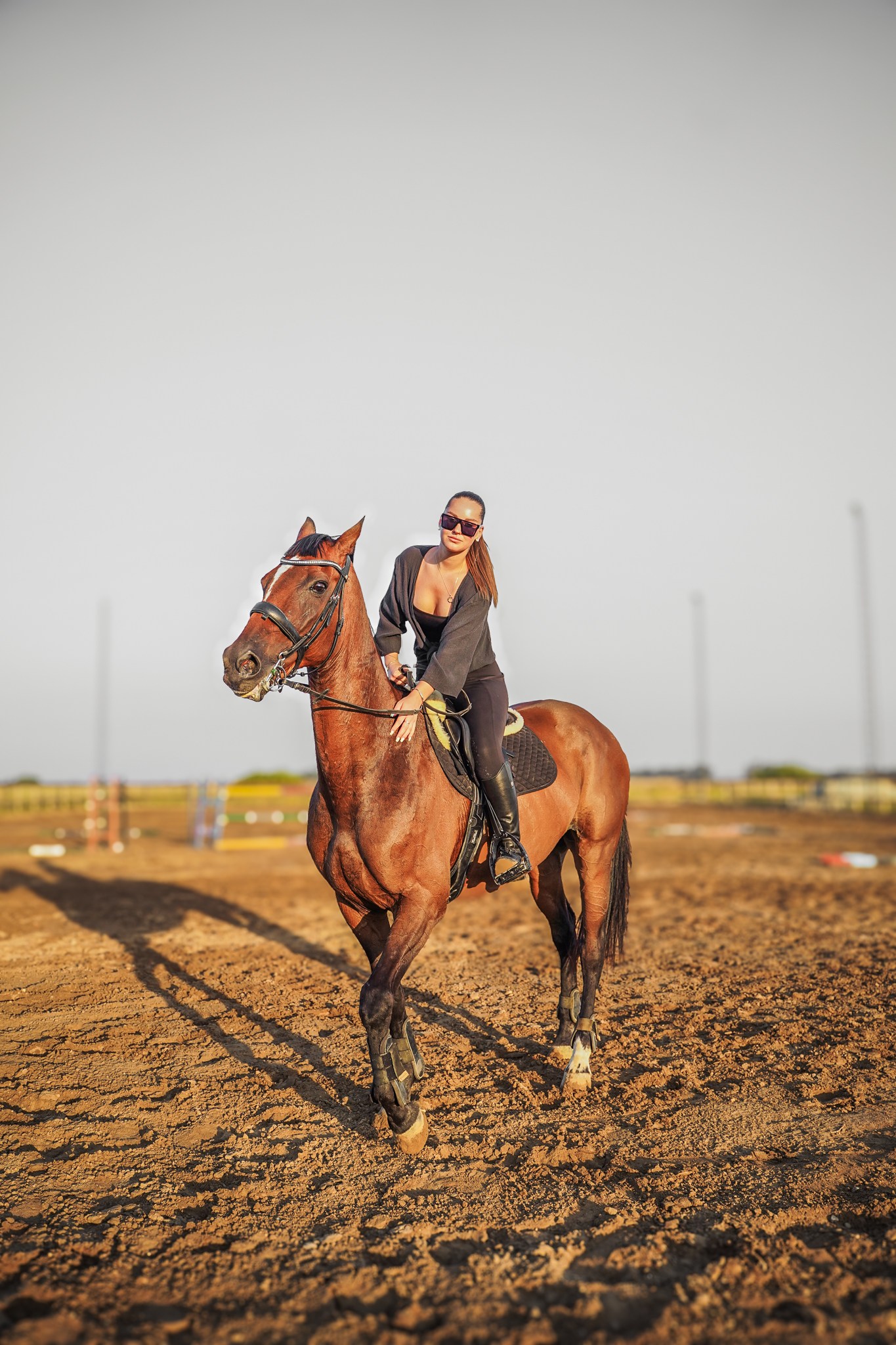 Anna riding her horse in the training arena